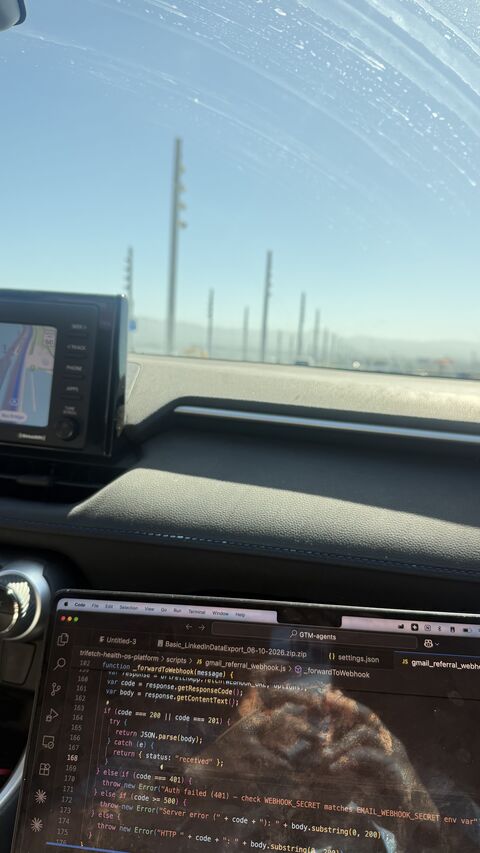 A laptop with GTM agent code open during a trip to prospect meetings
